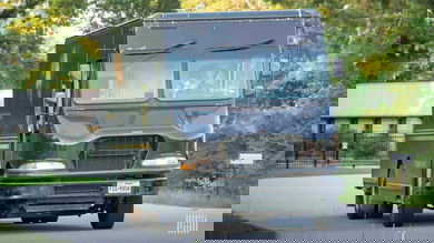A brown UPS package car driving.