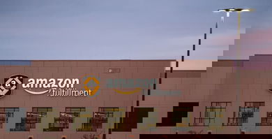 A brown Amazon warehouse with sign on front.