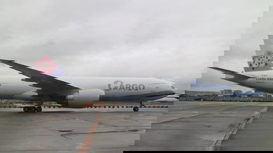 A side view of new China Airlines 777 on a gray day.