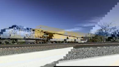 A photograph of a Union Pacific train traveling through a field.