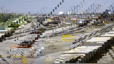 A photograph of rail cars parked in a rail yard.