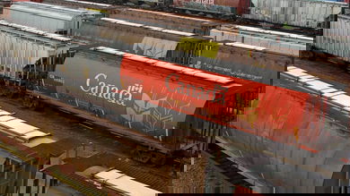 A photograph of grain hopper cars in a rail yard.