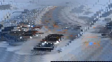 Traffic buildup behind snow plows on a Colorado highway.