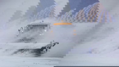 Plow trucks clearing runways at Denver International Airport.