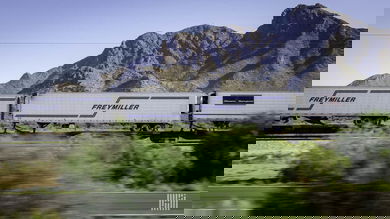 A photograph of a train carrying intermodal trailers.