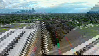 A photograph of a rail yard with a city in the distance.
