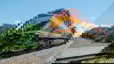 A photograph of a Kansas City Southern train turning around the curve.