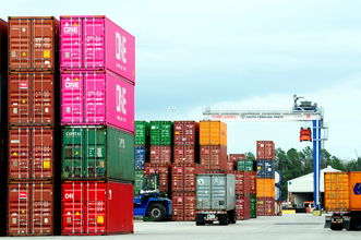 A photograph of containers stacked at a yard.