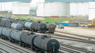 A photograph of railcars parked in a rail yard.