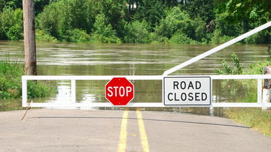 Road Closed sign in flooded area.