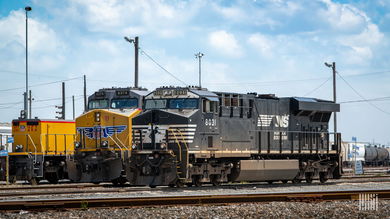 A photograph of a Union Pacific locomotive and a Norfolk Southern locomotive parked in a rail yard.
