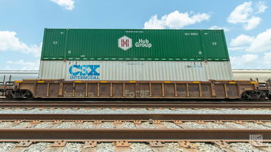 A photograph of a two intermodal containers stacked on top of a train.