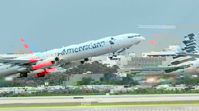 An American Airlines jet lifts off from runway.