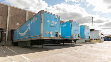 Amazon trailers sit outside an Amazon warehouse