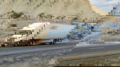 A white J.B. Hunt tractor-trailer on highway