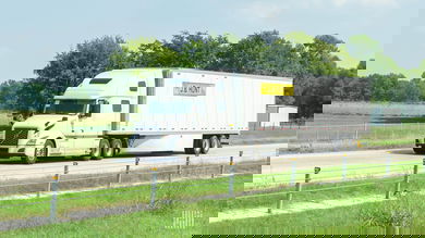 A white J.B. Hunt tractor pulling a white J.B. Hunt trailer