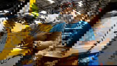 Amazon fulfillment center worker and robot