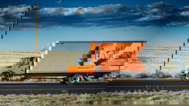 Orange truck on highway