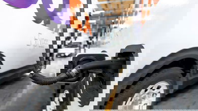 View of FedEx electric van plugged into charging unit