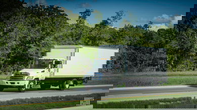 White box truck driving down the highway