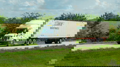 A J.B. Hunt tractor pulling a J.B. Hunt intermodal container