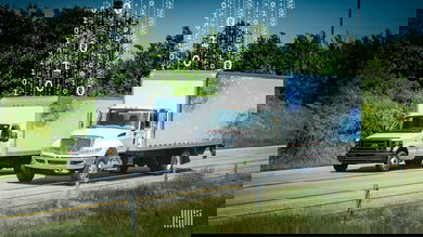 2 white trucks driving down the road
