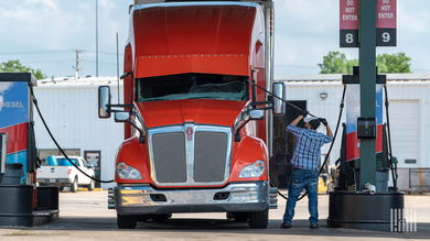 Driver with truck at service station