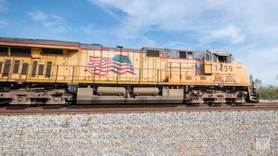 A Union Pacific locomotive travels down railroad track.