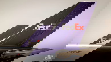 Close up of purple tails on two FedEx planes.
