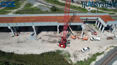 Image shows aerial view of railroad bridge under construction.