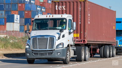 trucks with containers leaving a port