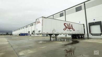 A Saia trailer loading at a terminal after a storm