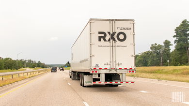 A rearview of an RXO trailer on a highway