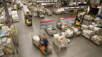 Bins of mail inside a Canada Post mail processing center.