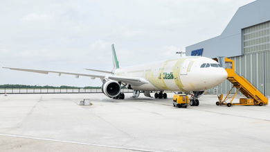 A large jet with stripping where airframe modifications were done for the plane to carry cargo containers. The plane will be painted later.