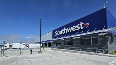 Front view of a Southwest Airlines cargo terminal with a large truck at the door.