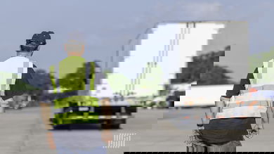Man watching truck with driver in skills test