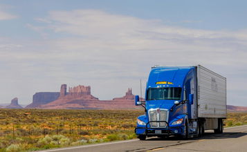 A Prime Inc. semitruck on a highway in the Mountain West region of the U.S.
