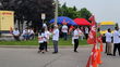 Union workers with red Unifor signs picket outside a DHL Express facility.