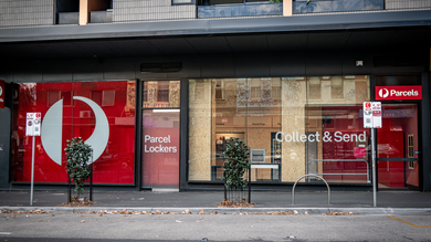 Front view of an Australia Post Parcel office, with red signage.
